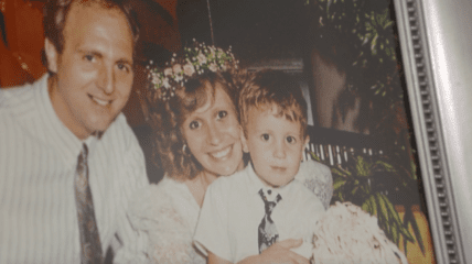 Photo of a family in a frame off center and faded.