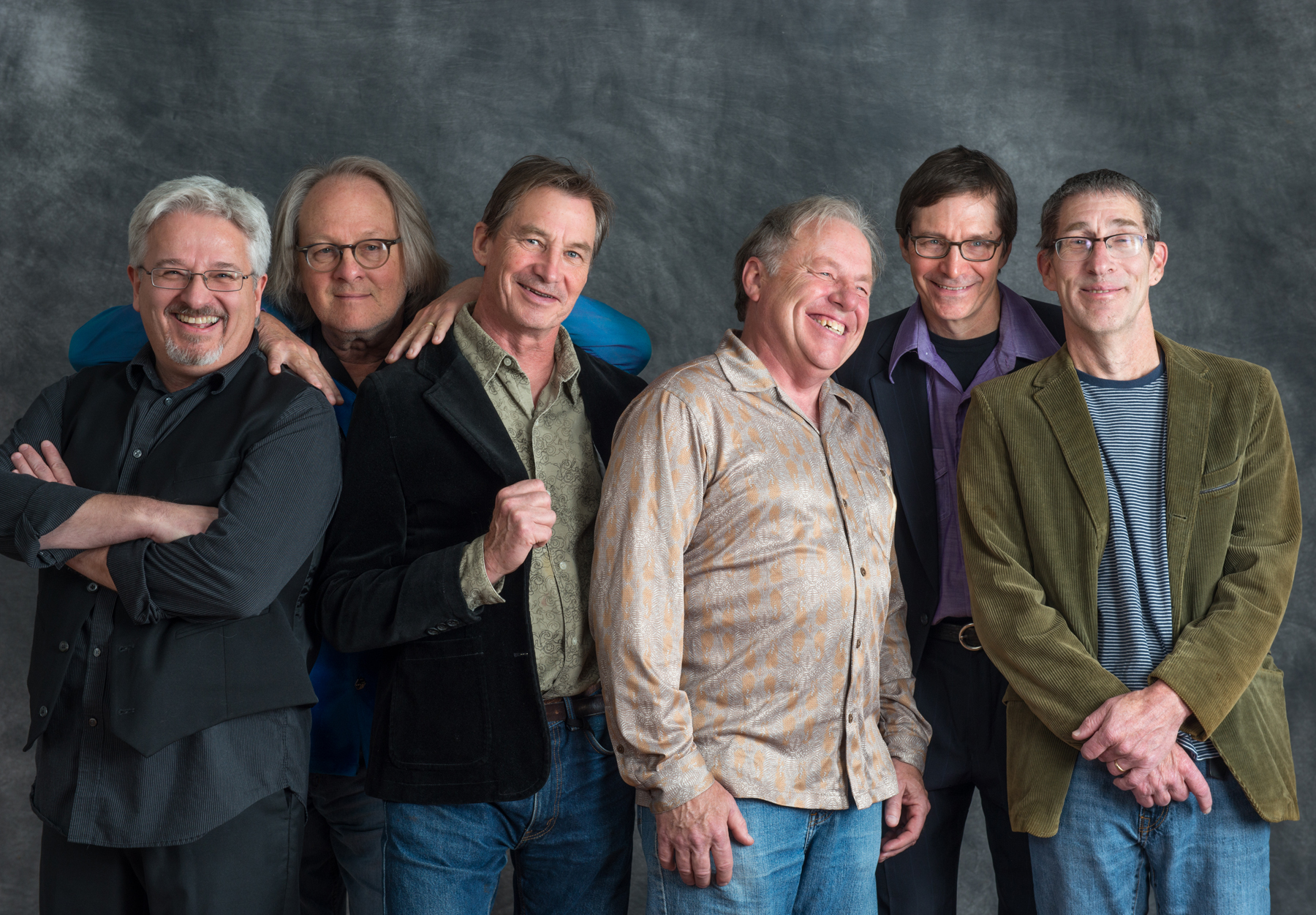 Six white males representing the band "Watkins and the Rapiers" stand together smiling at the camera.