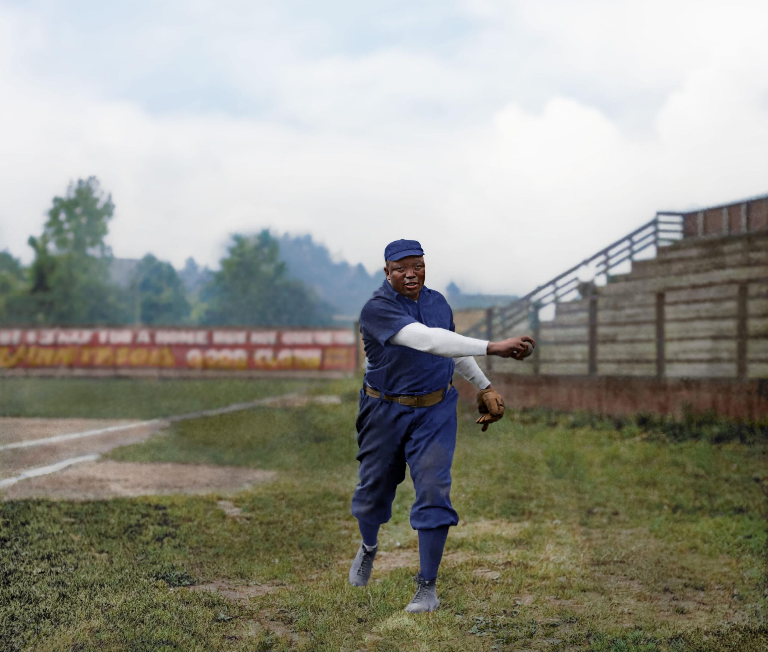 Baseball player Rube Foster throwing a baseball on a baseball field.