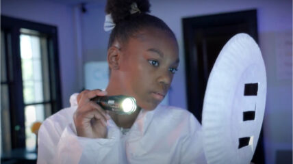 Bending the Light: Student shines a flashlight through a pattern cut out of a paper plate