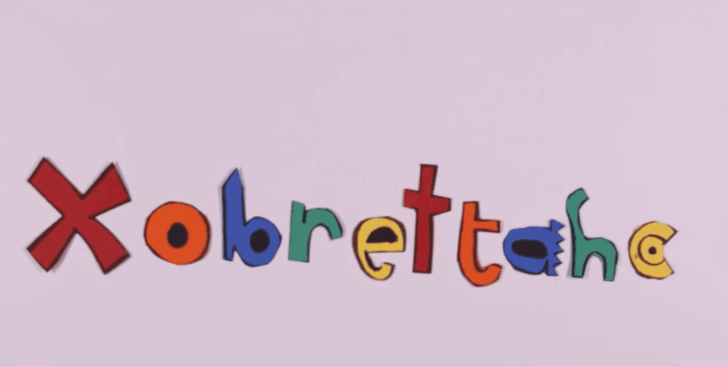 Light purple background with a the word xobrettahc - all the letters are in different colors.