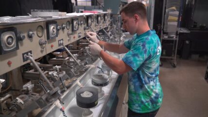 An optician working in commercial optics manufacturing.