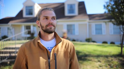 Man standing in front a a house