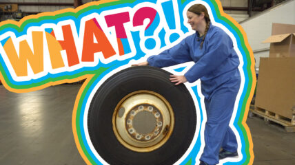 What?! Jen Indovina rolling a truck tire for the mechanic career segment