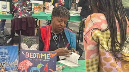 Children's author signing a book for a fan