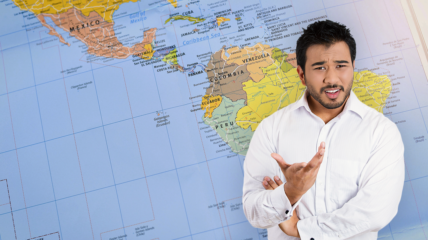 A Latino man stands in front of a map of Latin America