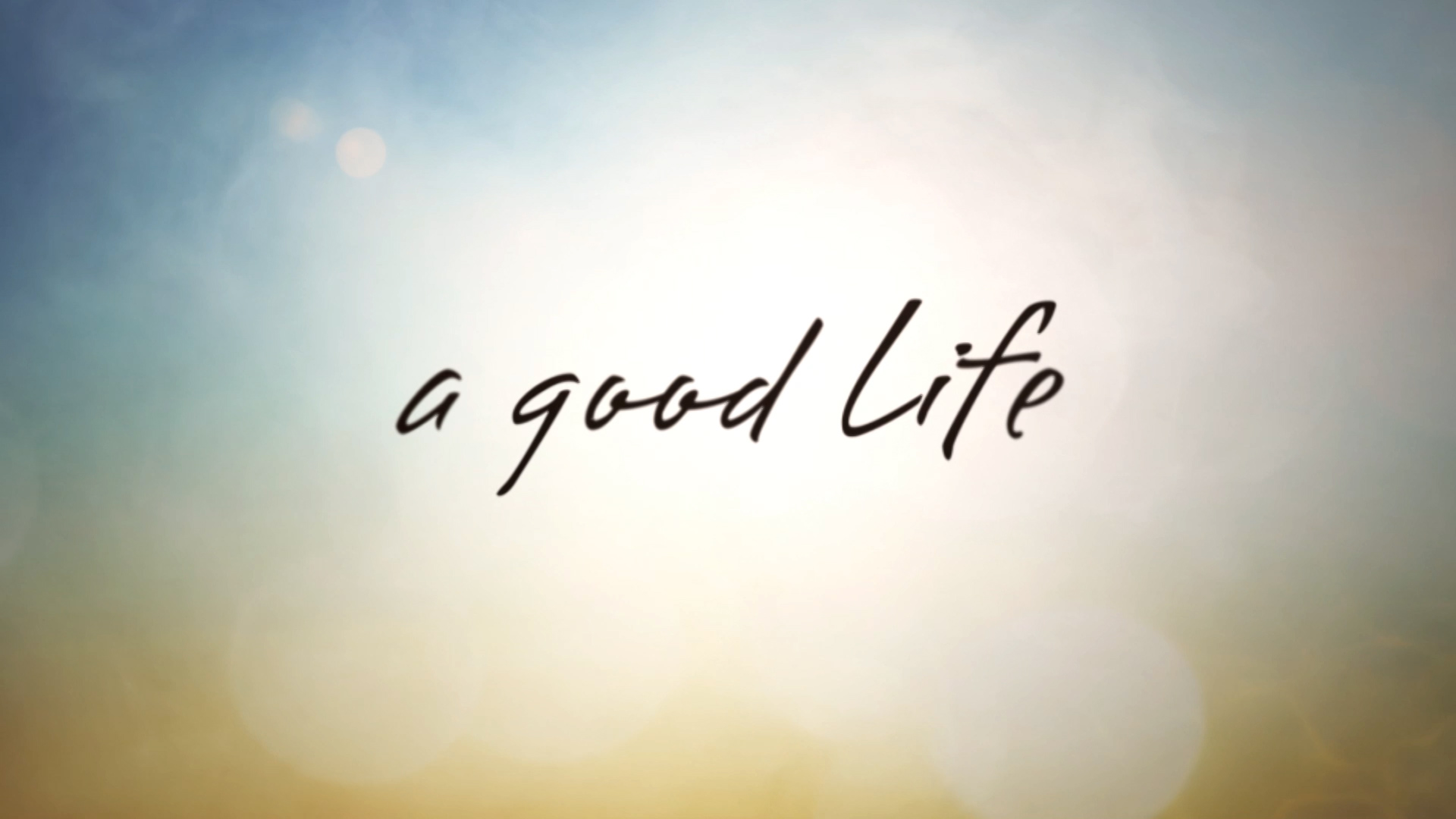 Glowing yellow background with Black type over top that reads: a good life