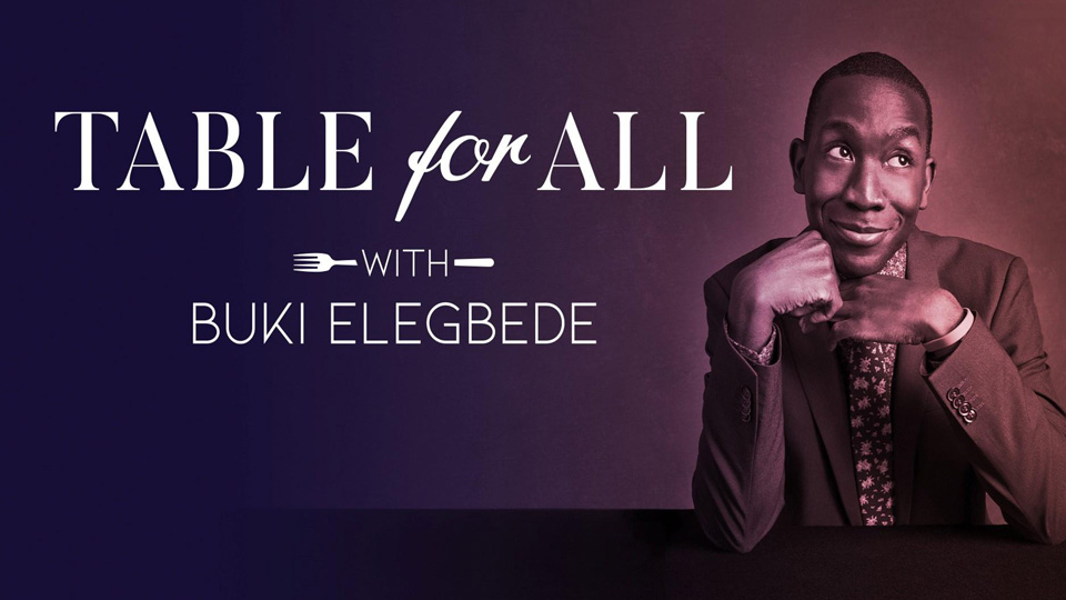 A Black man with short brown hair sits at a table with his hands folded under his chin. White type read: Table for All