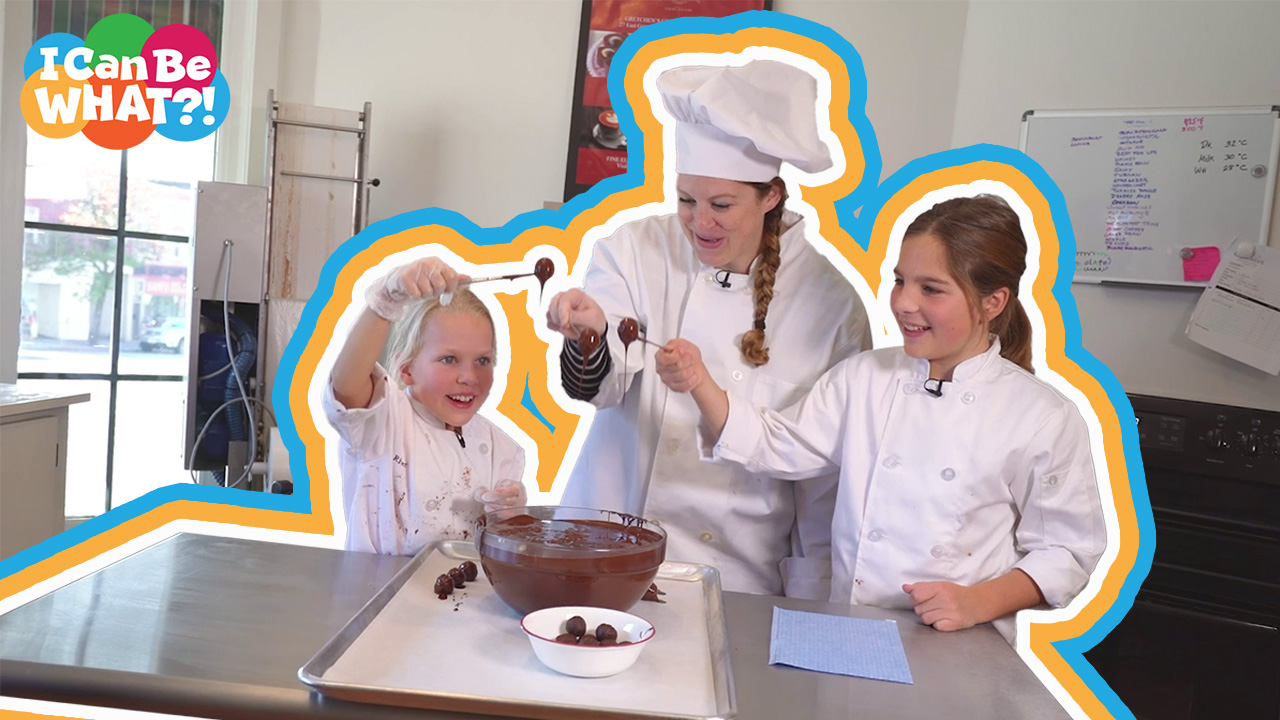 Woman in chef hat and two young girls making chocolate