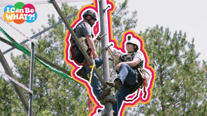 Two technicians climbing a tower wearing helmets and safety equipment
