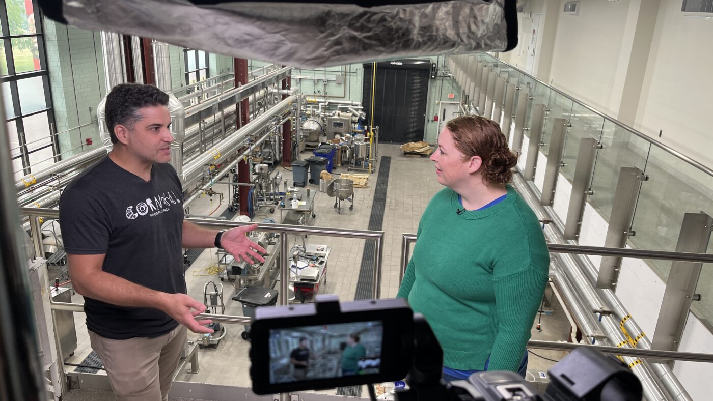 Man and woman being filmed in a plant