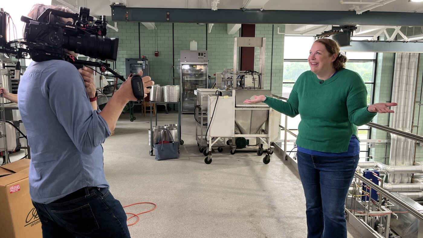 Woman being filmed in a plant