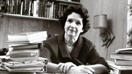 Rachel Carson sitting at a desk