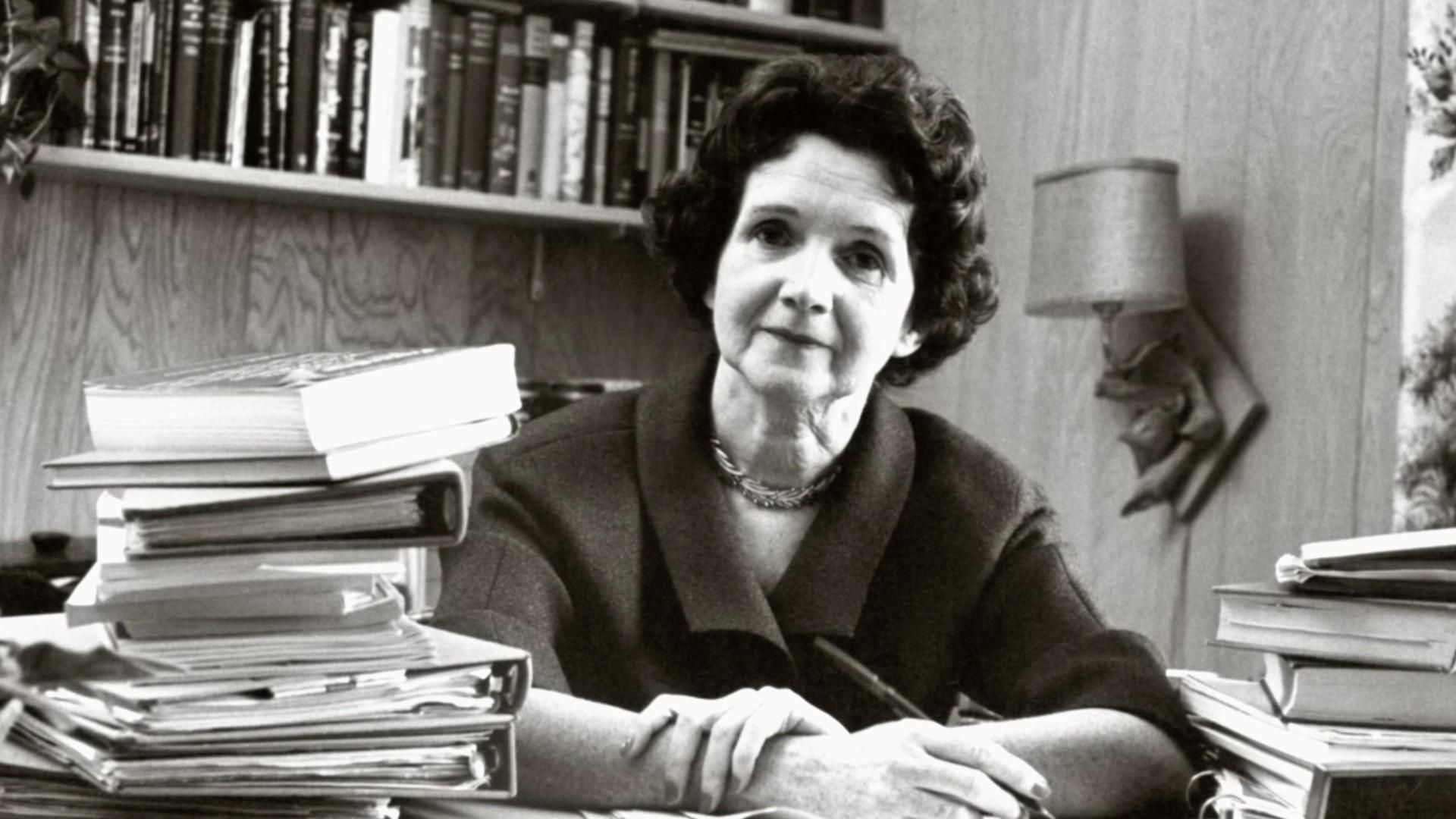 Rachel Carson sitting at a desk