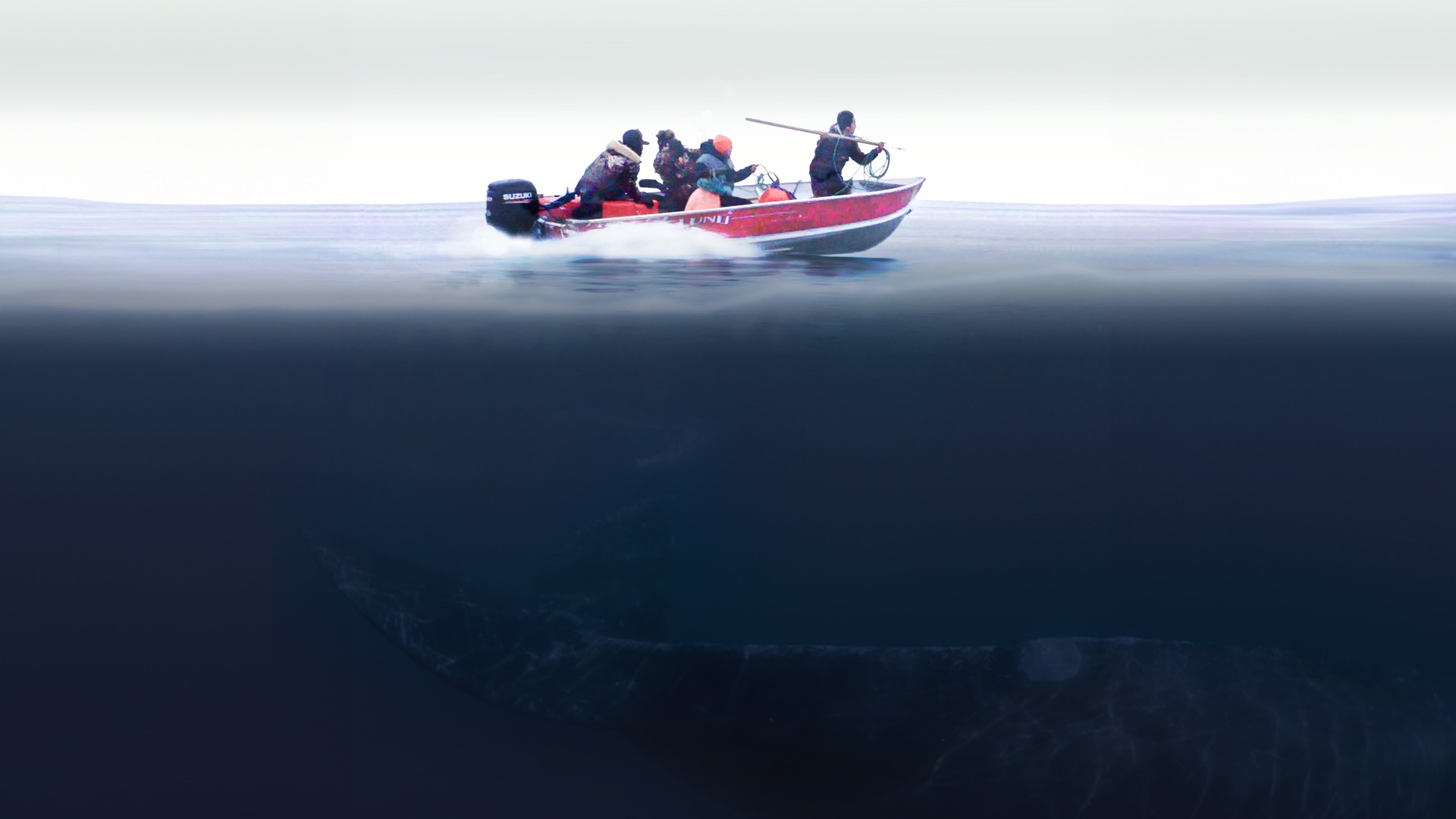 Four fishermen on a red fishing boat on the ocean