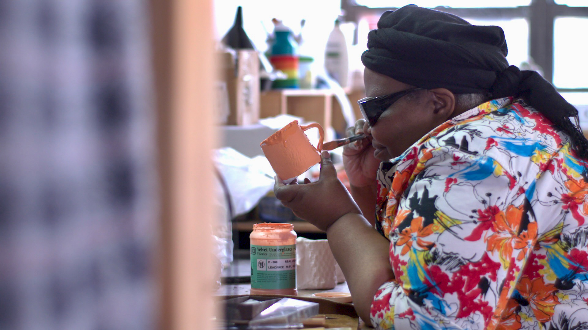 man shown painting a cup