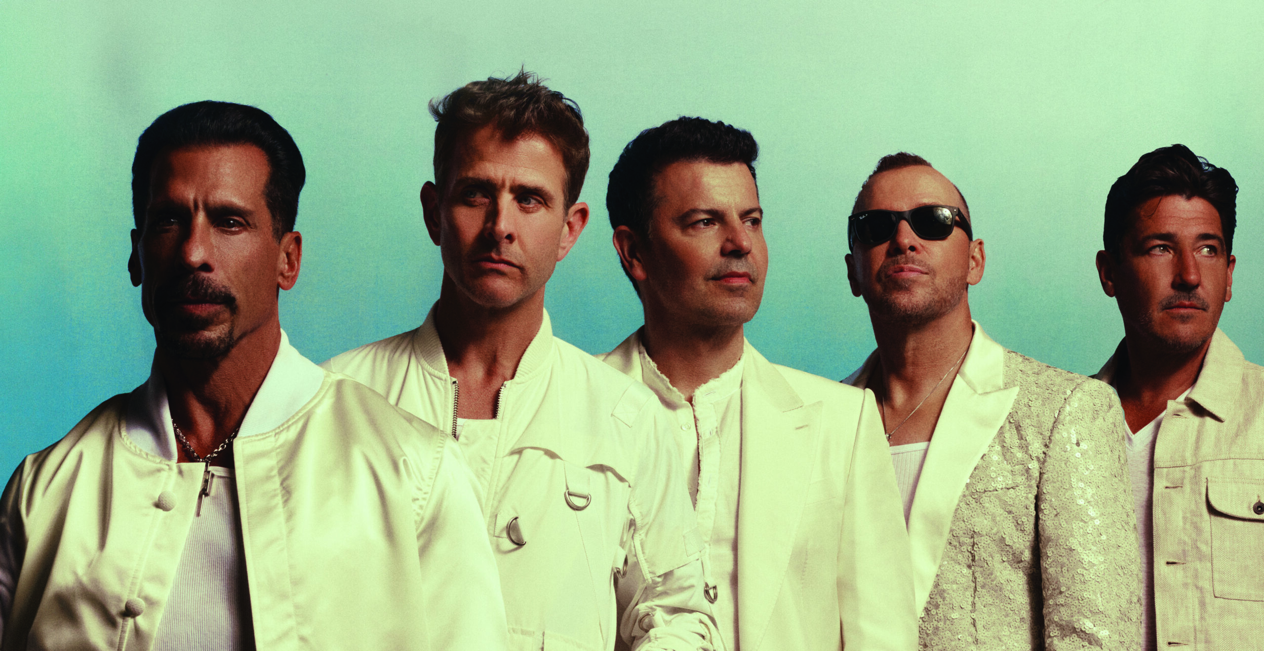 The band New Kids on the Block wearing white jackets