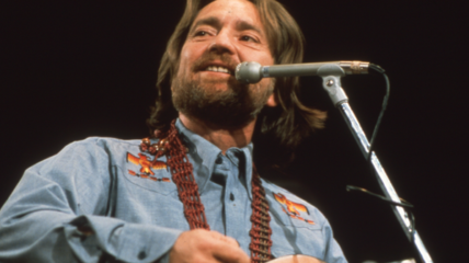 Willie Nelson in 1974 on stage singing