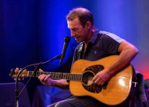 Musician John Dady playing the guitar