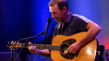Musician John Dady playing the guitar