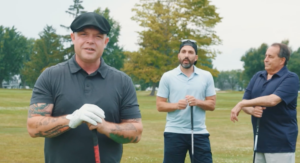 Three guys on a gold course holding clubs