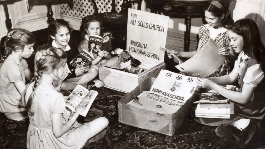 A group of American children opening packages and reading Japanese books