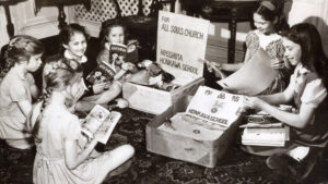 A group of American children opening packages and reading Japanese books