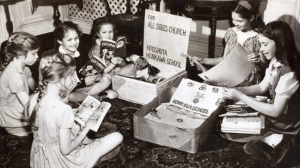 A group of American children opening packages and reading Japanese books