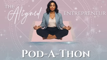 A Black woman wearing a light blue blazer, white shit, and navy pants sits with her legs crossed with hands resting onher knees.