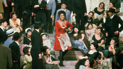 Grace Bumbry wearing a red dress performing on stage.