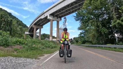 A man riding his bike along the Ohio river
