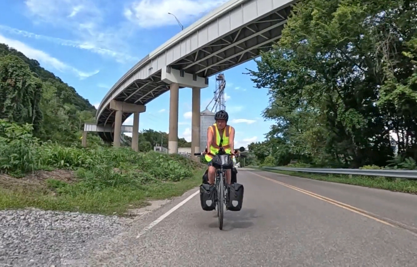 A man riding his bike along the Ohio river