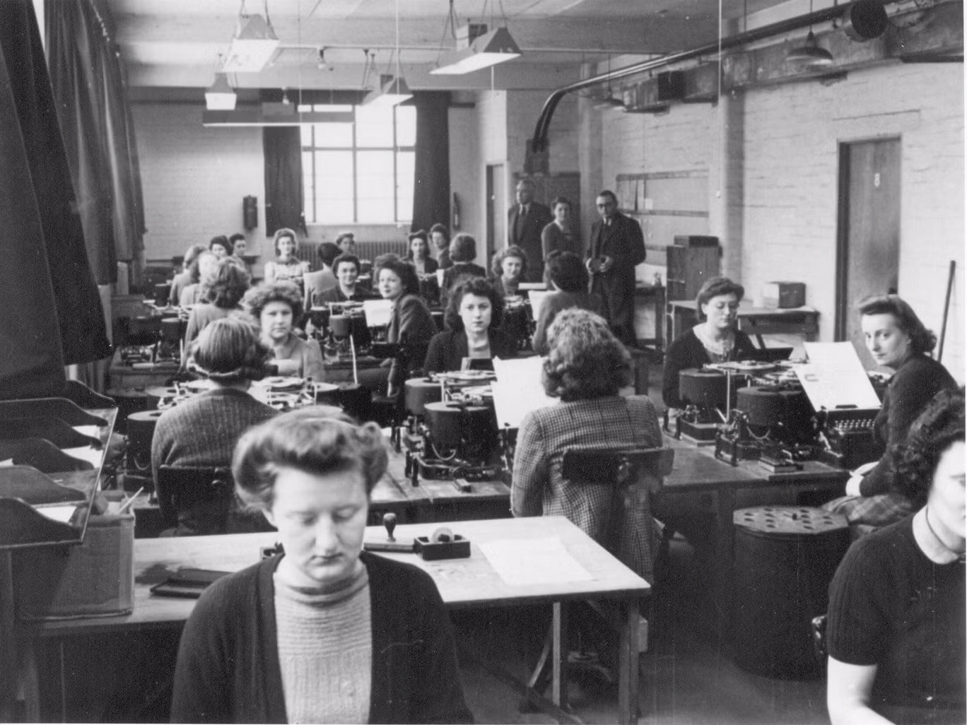 A group of woman sitting at desks working to crack German military code