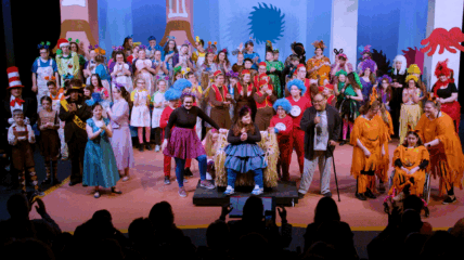 A group of kids on stage acting out a play.
