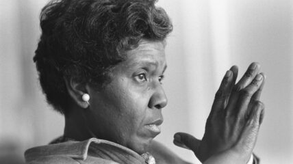 A close up blacka nd white shot of Barbara Jordan. She has her hangs together in front of her face looking pensive.