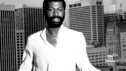 Singer Teddy Pendergrass wearing a white suit