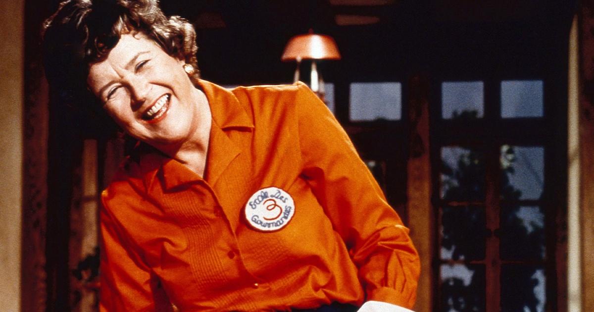 Julia Childs wearing a red blouse laughing