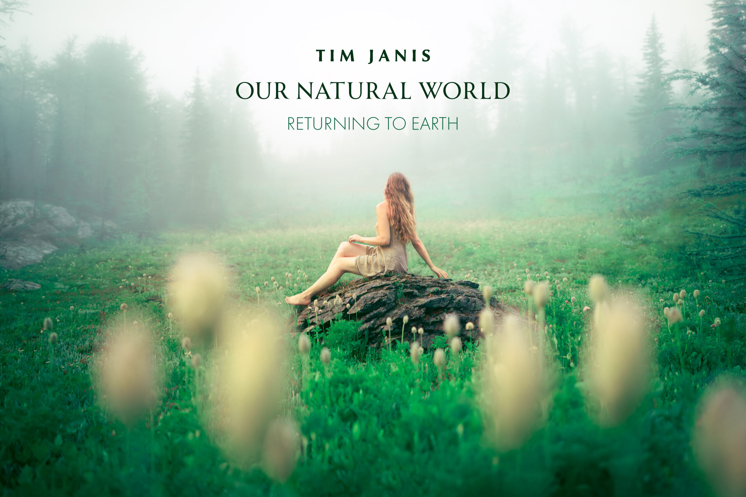 A white woman with long red hair wearing a light brown dress sis on a rock in the middle of a green field with white flowers.