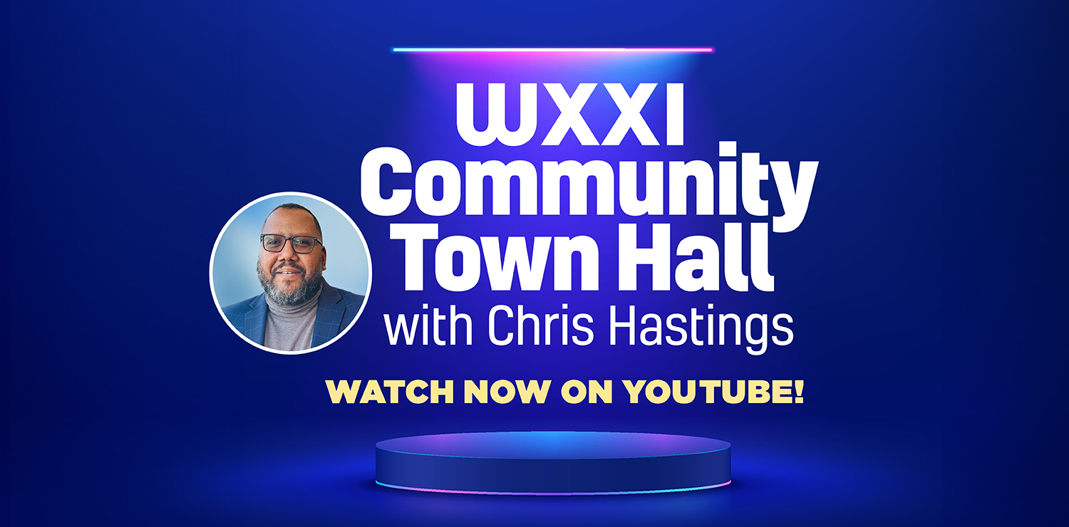 WXXI President Chris Hastings wearing a gray shirt and blue blazer with copy in white text on a blue background that reads: WXXI COMMUNITY TOWN HALL with Chris Hastings WATCH NOW