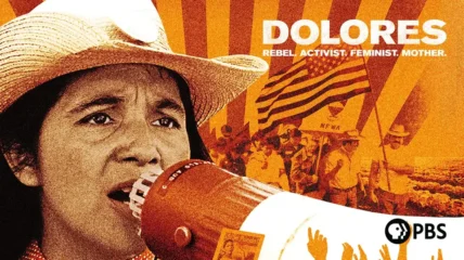 Stylized poster image showing feminist icon Dolores Huerta wearing a wide‑brimmed hat speaking into a megaphone in the foreground. In the background are farm fields, marching workers holding flags, and radiating orange and yellow rays. Large text reads “DOLORES” with smaller text “REBEL. ACTIVIST. FEMINIST. MOTHER.” A PBS logo appears in the lower right corner.