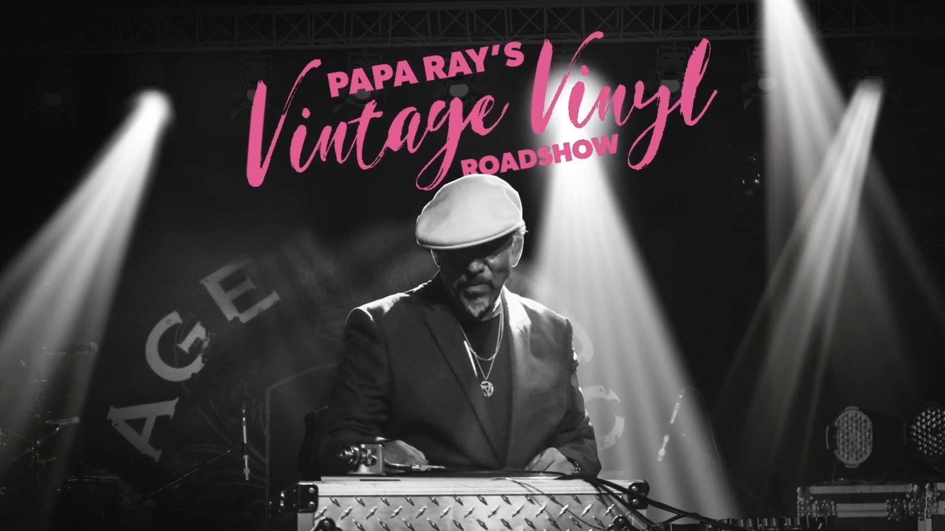 DJ Papa Ray in a suite and cap behind a sound system spinning records. Hot pink type reads Papa Ray's Vintage Vinyl Roadshow