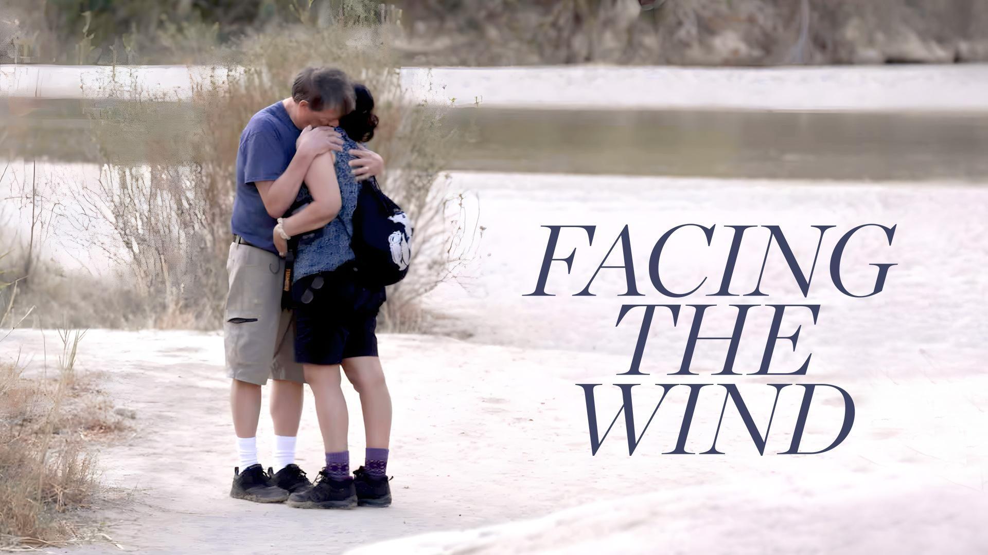 A man and woman hugging on a beach