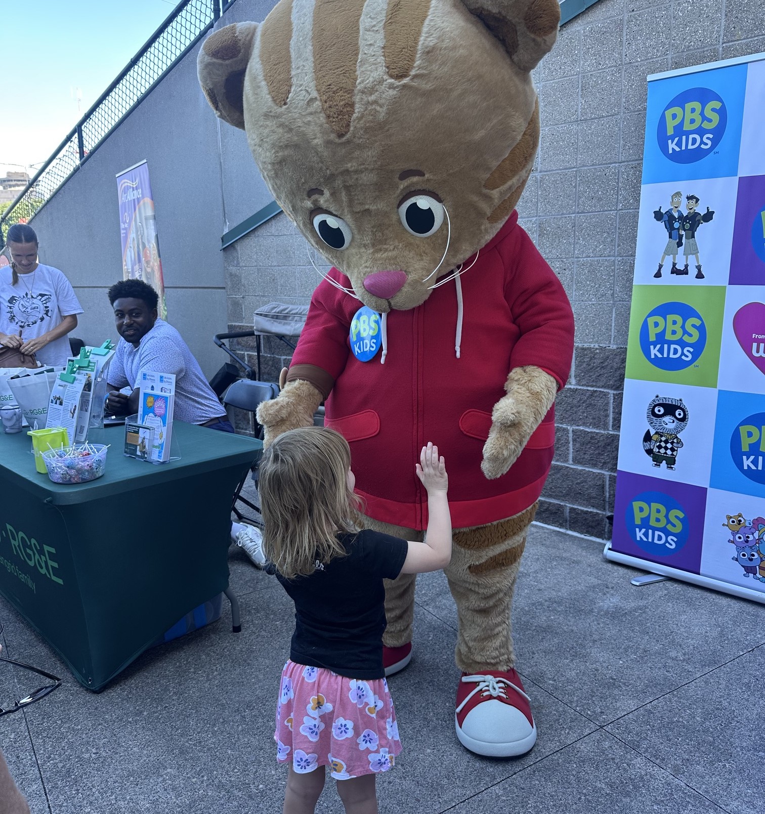 Child meeting Daniel Tiger Costume character at a WXXI event out in the community