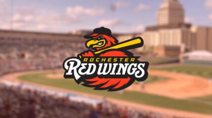 Rochester Red Wings logo with a background of the field