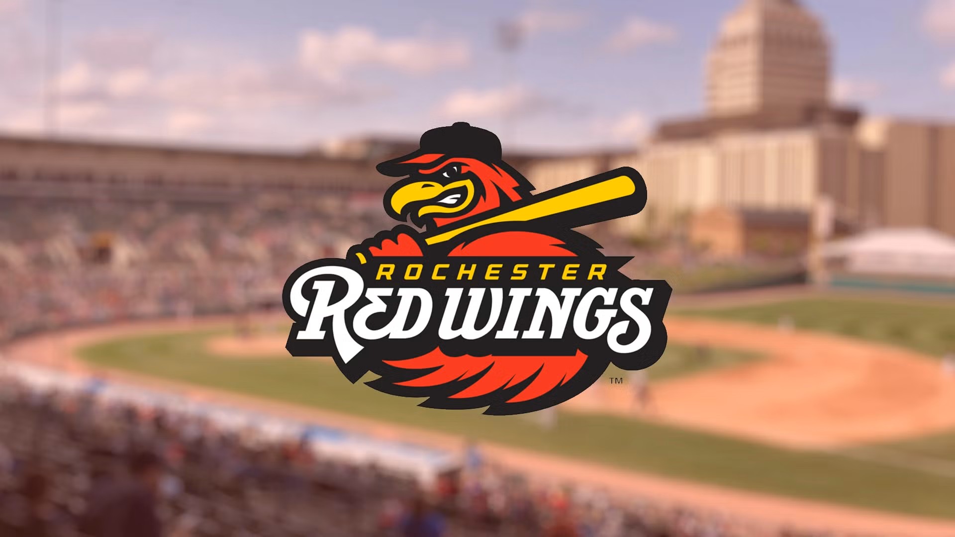Rochester Red Wings logo with a background of the field