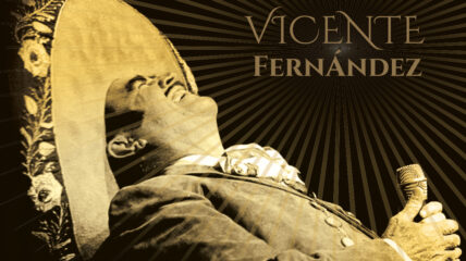 Vicente Fernandez stands holding a microphone