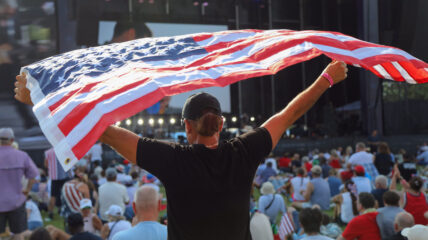 A spectator held an American flag aloft during the Freedom 250 celebration in Washington on July 4, 2026.
