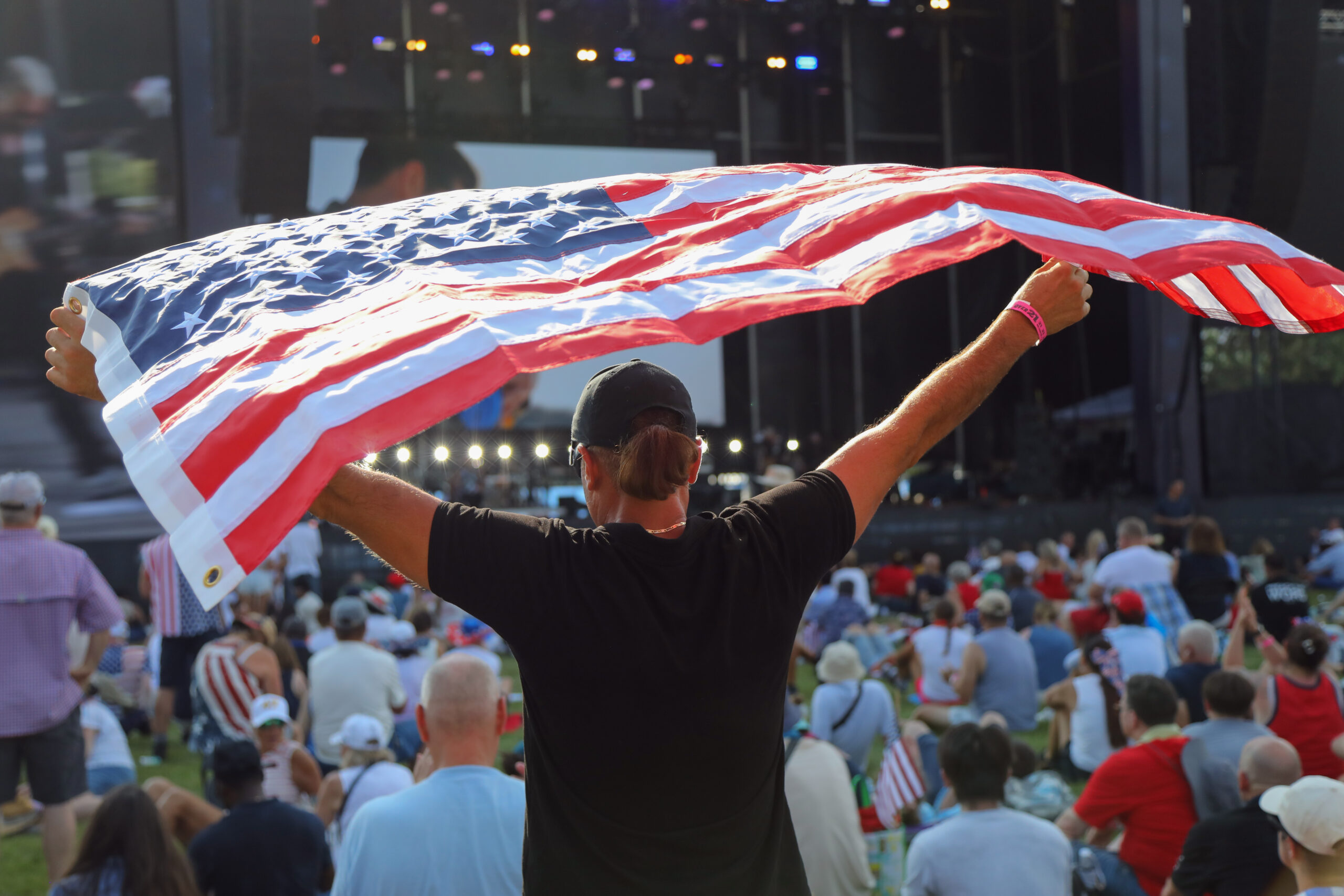 A spectator held an American flag aloft during the Freedom 250 celebration in Washington on July 4, 2026.